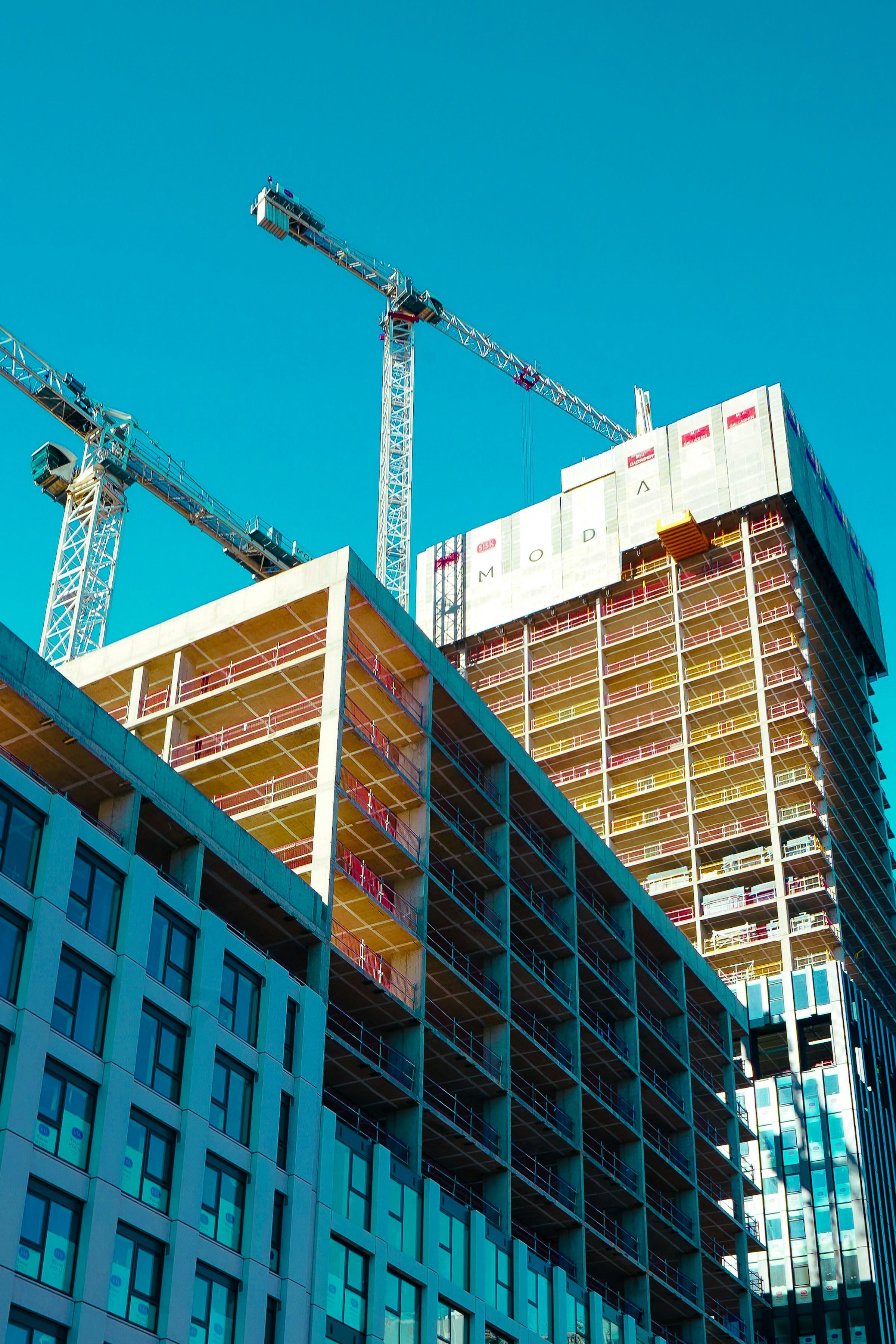 A construction team working across a large structural frame